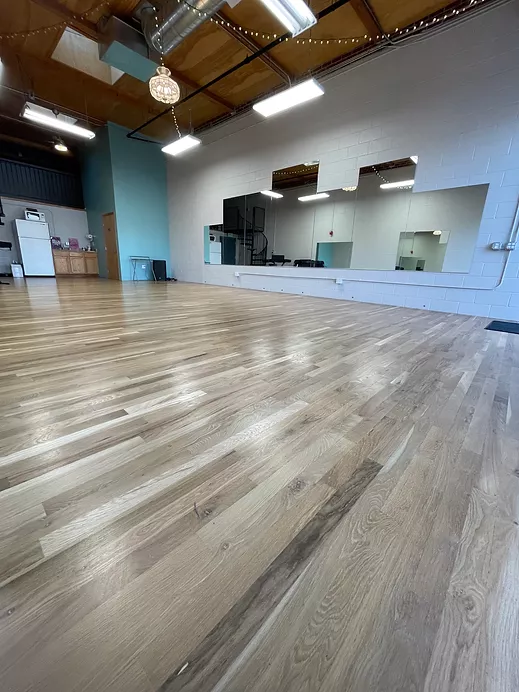 APEX studio interior with wood floors and mirrors